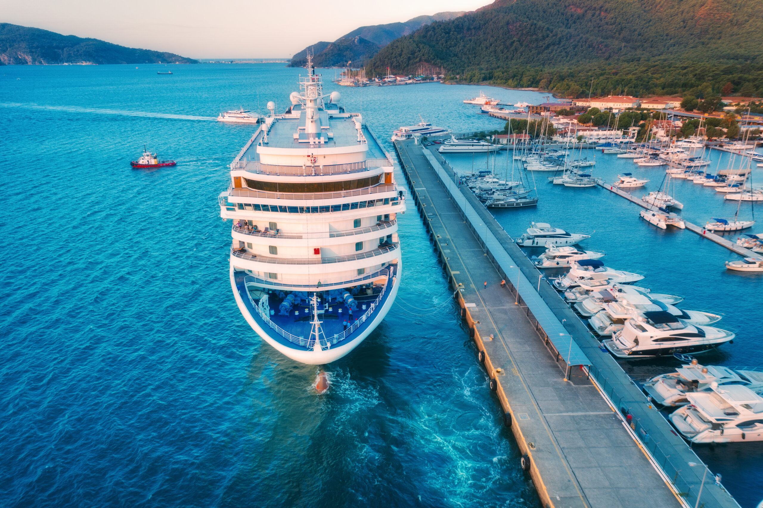 Aerial view of beautiful large white ship at sunset